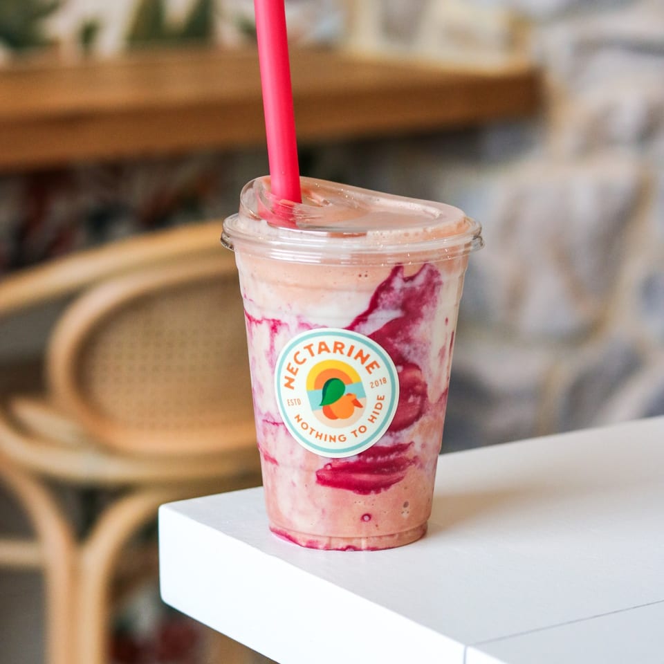 Pink swirled smoothie in a Nectarine cup.
